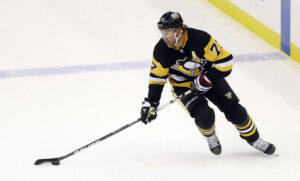 Pittsburgh Penguins center Jeff Carter (77) skates with the puck against the New Jersey Devils during the second period at PPG Paints Arena. 