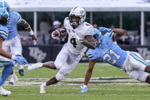 UCF Knights wide receiver Ryan O'Keefe (4) runs the ball against Tulane Green Wave defensive back Ajani Kerr (21) during the second quarter.