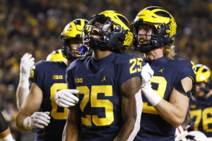 Michigan Wolverines running back Hassan Haskins (25) his celebrates touchdown with tight end Luke Schoonmaker (86) and tight end Carter Selzer (89) in the first half against the Indiana Hoosiers at Michigan Stadium. 