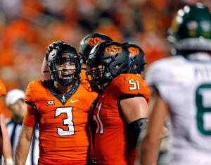 Oklahoma State's Spencer Sanders (3) celebrates with teammates after a victory over Baylor