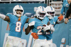 Miami Dolphins cornerback Justin Coleman (center) holds the football and celebrates with teammates after intercepting the football against the Baltimore Ravens