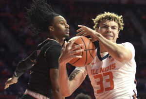 Illinois Fighting Illini forward Coleman Hawkins (right) pulls down a rebound in front of Arkansas State Red Wolves forward Markise Davis (left)