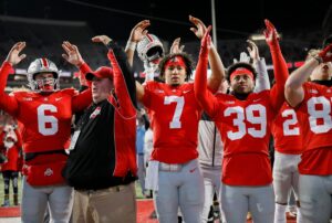 Ohio State Buckeyes quarterback Kyle McCord (6), quarterback C.J. Stroud (7) and defensive back Andrew Moore (39) sing the school's fight song after a victory over Purdue