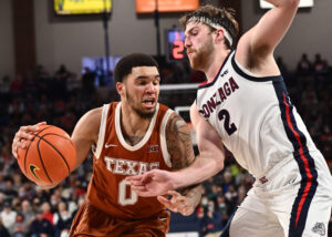 Texas Longhorns forward Timmy Allen (left) drives the lane against Gonzaga Bulldogs forward Drew Timme (right)