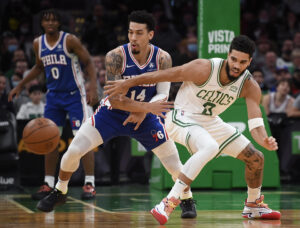 Philadelphia 76ers forward Danny Green (left) and Boston Celtics forward Jayson Tatum (right) prepare to go after a loose ball during a game