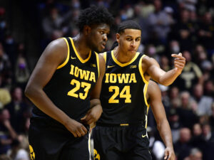 Iowa Hawkeyes forward Josh Ogundele (left) and Iowa Hawkeyes forward Kris Murray (right) have a discussion while walking back onto the court during a game against Purdue