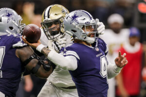 New Orleans Saints defensive end Carl Granderson (left) grabs the face mask of Dallas Cowboys quarterback Dak Prescott (right) while attempt to make a sack