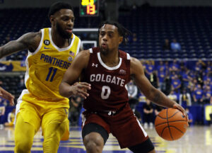 Wednesday College Basketball Odds - Colgate Raiders guard Nelly Cummings (right) goes to the basket with the basketball in his left hand while be defending by Pittsburgh Panthers guard Jamarius Burton (left)