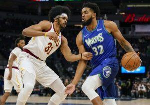 Minnesota Timberwolves center Karl-Anthony Towns (right) controls the ball as Cleveland Cavaliers center Jarrett Allen defends 