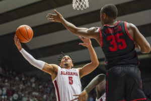 Alabama Crimson Tide guard Jaden Shackelford (left) grabs a rebound against Houston Cougars