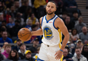 Golden State Warriors guard Stephen Curry dribbles the ball up court in a game against the Indiana Pacers