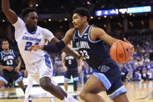 Villanova Wildcats forward Jermaine Samuels (left) drives with the basketball in his left hand and Creighton Bluejays forward Arthur Kaluma (right) applies defensive pressure during a Big East basketball game