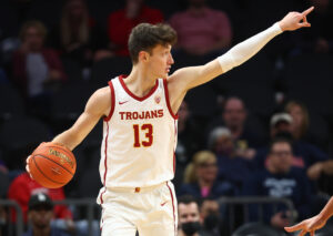 Southern California Trojans guard Drew Peterson points to a teammate while dribbling the basketball up the court against the Georgia Tech Yellow Jackets