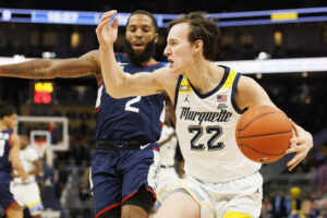 Marquette Golden Eagles guard Tyler Kolek (right) drives for the basket against Connecticut Huskies guard RJ Cole (left) during a Big East basketball game