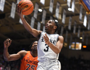 Duke Blue Devils guard Jeremy Roach (right) lays the basketball up with his right hand after driving past Virginia Tech Hokies forward Justyn Mutts (left) during an ACC basketball game