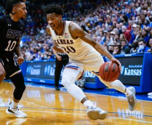 Kansas Jayhawks guard Ochai Agbaji (right) drives against Stephen F. Austin Lumberjacks guard Latrell Jossell (left)