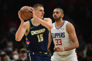 Denver Nuggets center Nikola Jokic (right) controls the ball against Los Angeles Clippers forward Nicolas Batum