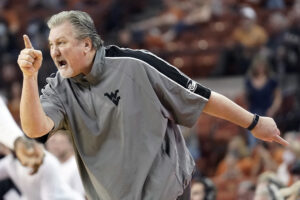 West Virginia Mountaineers head coach Bob Huggins yells out to players during the first half against the Texas Longhorn