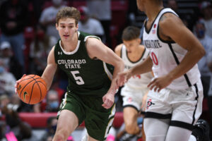 Colorado State Rams guard Baylor Hebb (right) dribbles the basketball with his right hand and heads up the court during a Mountain West Conference game against the San Diego State Aztecs