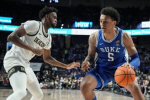 Duke Blue Devils forward Paolo Banchero (right) drives to the basket against Wake Forest Demon Deacons forward Isaiah Mucius (left) during an ACC basketball game