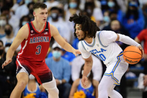 UCLA Bruins guard Tyger Campbell (right) controls the ball against Arizona Wildcats guard Pelle Larsson (left) during a Pac-12 Conference basketball game at UCLA