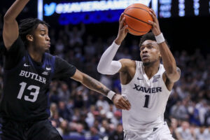 Wednesday College Basketball Odds - Xavier Musketeers guard Paul Scruggs (right) drives to the basket with the basketball in both hands as Butler Bulldogs guard Jayden Taylor (;eft) defends during a Big East basketball game