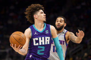 LaMelo Ball (left) looks to drive to the basket while Detroit Pistons guard Cory Joseph (right) defends