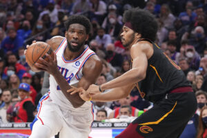 Philadelphia 76ers center Joel Embiid (left) holds the ball as he prepares to drive to the basket against Cleveland Cavaliers center Jarrett Allen (right)