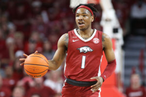 Arkansas Razorbacks guard JD Notae dribbles the ball upcourt against the Tennessee Volunteers during an SEC basketball game