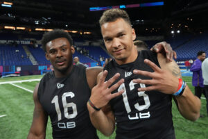 Liberty Flames quarterback Malik Willis (left) and Cincinnati Bearcats quarterback Desmond Ridder (QB13) pose during a break at the NFL Scouting Combine in Indianapolis