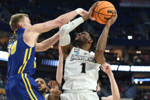 Providence Friars guard Al Durham (right) controls the basketball with both hands as he rises up to shoot against the South Dakota State Jackrabbits in an NCAA Tournament game