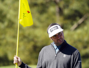 Bubba Watson holds the flag on no. 3 green during a practice round of The Masters golf tournament at Augusta National Golf Club on April 5, 2022.