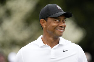 Tiger Woods smiles at the practice facility during a practice round of The Masters golf tournament at Augusta National Golf Club on April 6, 2022.