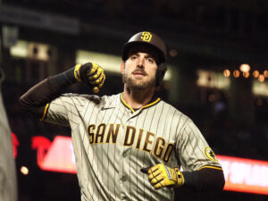 San Diego Padres catcher Austin Nola raises his right arm to high-five an unseen teammate after hitting a home run against the San Francisco Giants