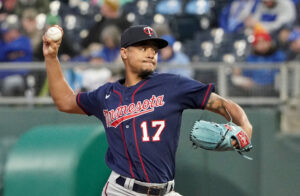 Minnesota Twins right-handed starting pitcher Chris Archer grips the baseball with his right hand and prepares to deliver a pitch against the Kansas City Royals 