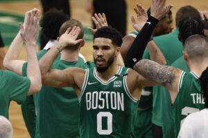 Boston Celtics forward Jayson Tatum (0) is congratulated by teammates during the third quarter of game two of the first round of the 2022 NBA playoffs against the Brooklyn Nets at TD Garden in Boston on Wednesday, April 20, 2022.