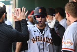 San Francisco Giants right fielder Joc Pederson shouts and high-fives teammates in the dugout after hitting a solo home run against the Washington Nationals