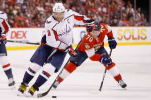 Washington Capitals left wing Alex Ovechkin (left) moves the puck ahead of Florida Panthers right wing Patric Hornqvist (right) during a 2022 Stanley Cup Playoff game