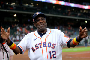 Houston Astros manager Dusty Baker smiles and raises his arms toward the fans after a victory May 3, 2022, in Houston.