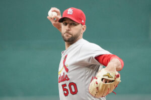 St. Louis Cardinals right-handed starting pitcher Adam Wainwright grips the baseball and delivers a pitch against the Kansas City Royals