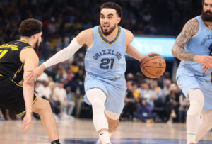 Memphis Grizzlies guard Tyus Jones (right) controls the ball as Golden State Warriors guard Klay Thompson (left) defends during game five of the second round for the 2022 NBA playoffs at FedExForum.