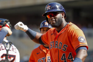 Houston Astros designated hitter Yordan Alvarez raises his right hand in celebration after hitting a home run May 12, 2022, in Minneapolis.