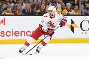 Carolina Hurricanes defenseman Tony DeAngelo (77) skates with the puck against the Boston Bruins during the second period at the TD Garden.