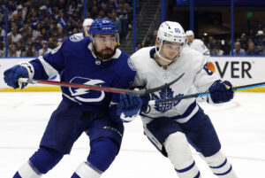 Tampa Bay Lightning left wing Nicholas Paul (left) and Toronto Maple Leafs right wing Ilya Mikheyev (right) skate after the puck during game six of a 2022 Stanley Cup Playoffs game