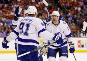 Tampa Bay Lightning right wing Corey Perry (right) celebrates with center Steven Stamkos (center, back turned) after scoring against the Florida Panthers during the first period in game two of the second round of the 2022 Stanley Cup Playoffs