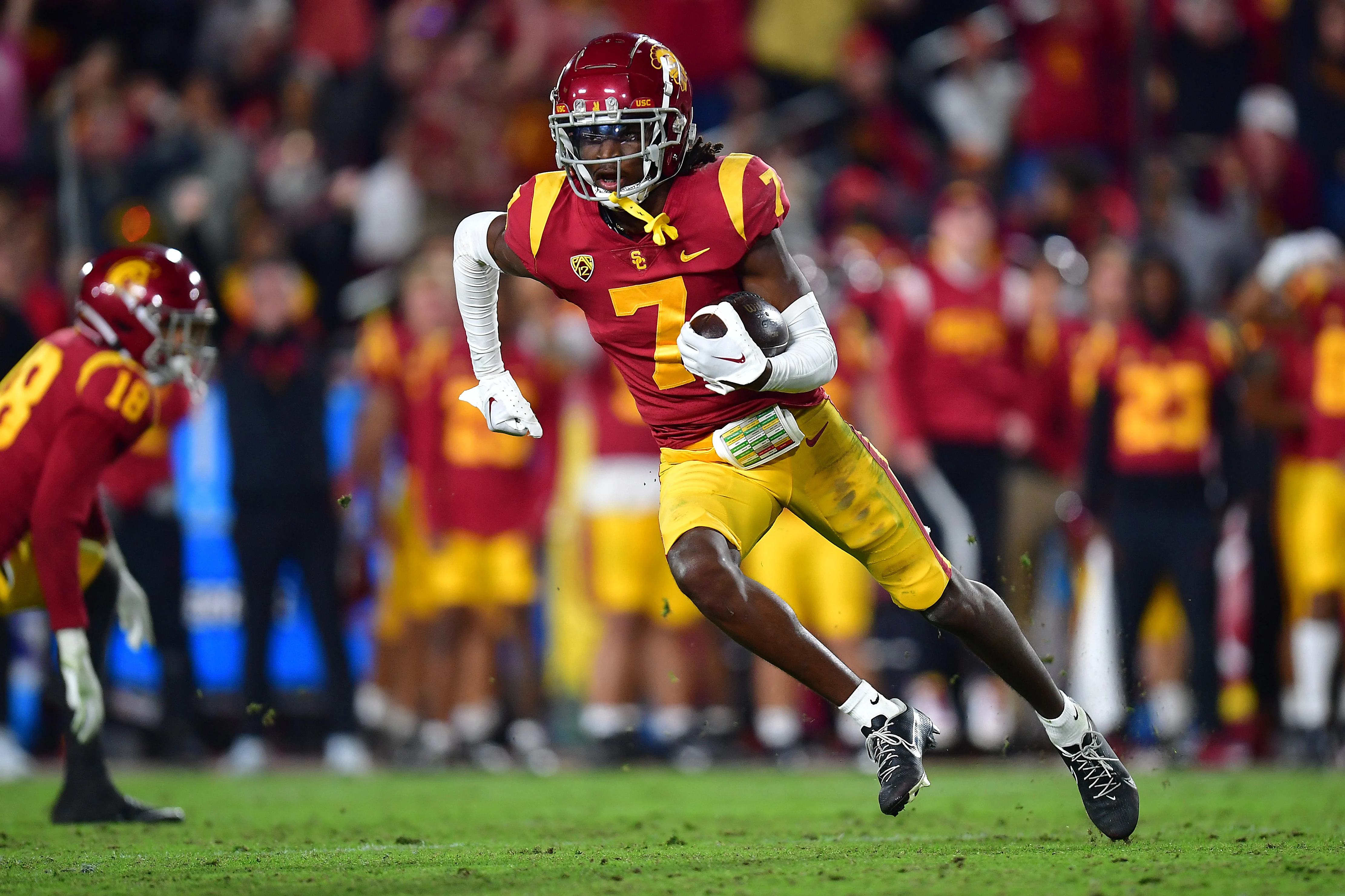 Nov 26, 2022; Los Angeles, California, USA; Southern California Trojans defensive back Calen Bullock (7) runs the ball after an interception against the Notre Dame Fighting Irish during the second half at the Los Angeles Memorial Coliseum.