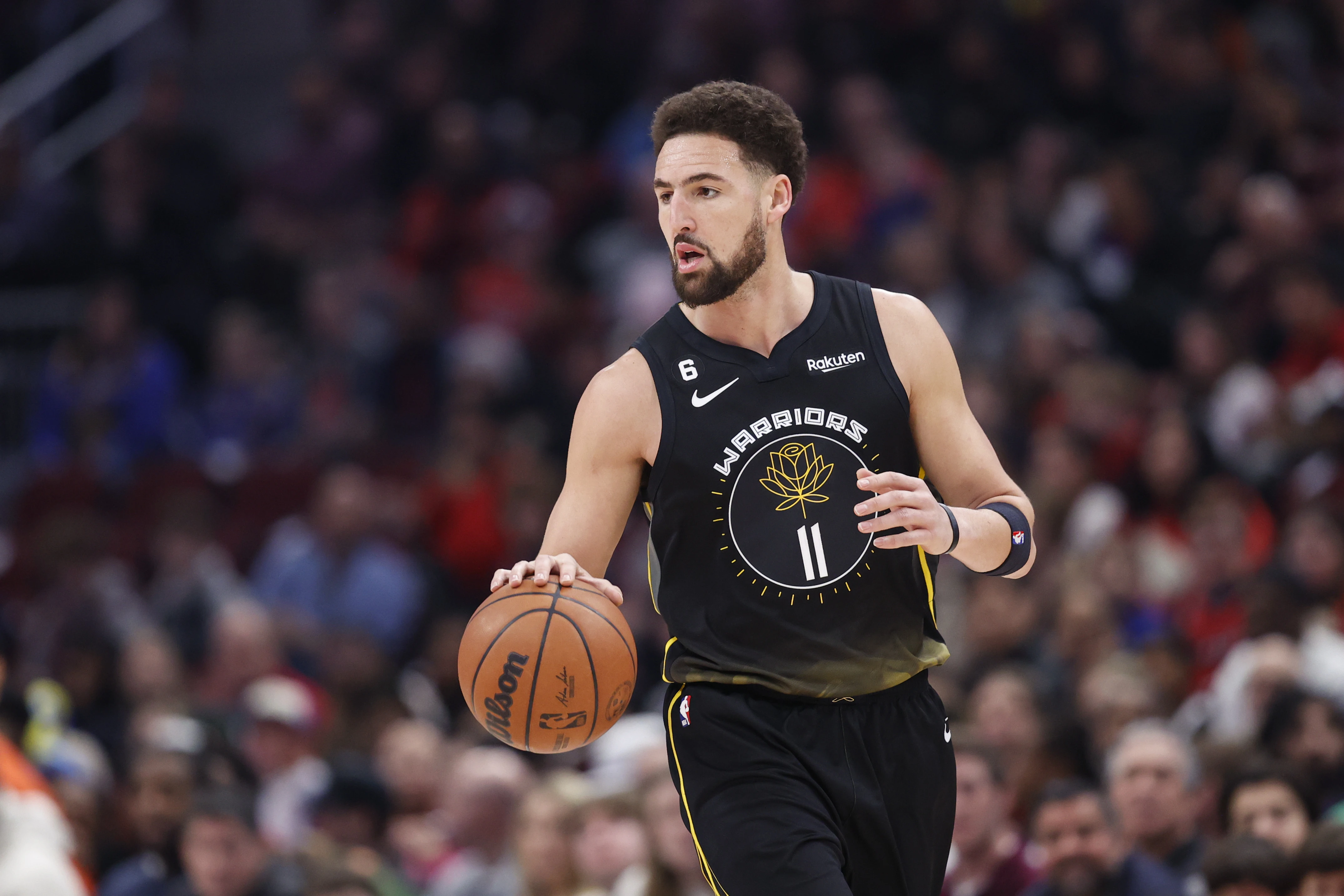 Golden State Warriors guard Klay Thompson (11) brings the ball up court against the Chicago Bulls during the first half of an NBA game at United Center.
