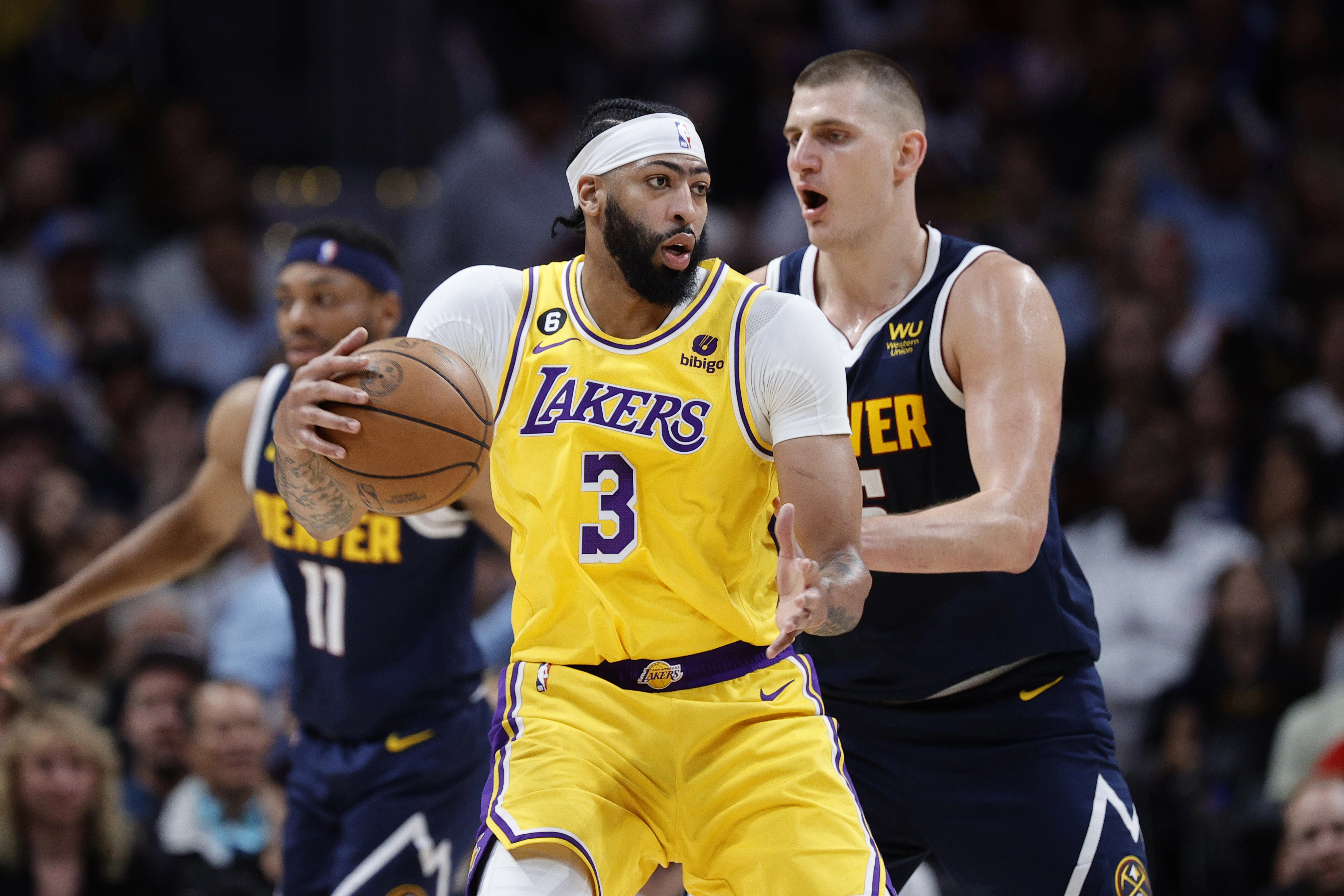 Los Angeles Lakers forward Anthony Davis (3) controls the ball against Denver Nuggets center Nikola Jokic (15) in the second quarter during game two of the Western Conference Finals for the 2023 NBA playoffs at Ball Arena.