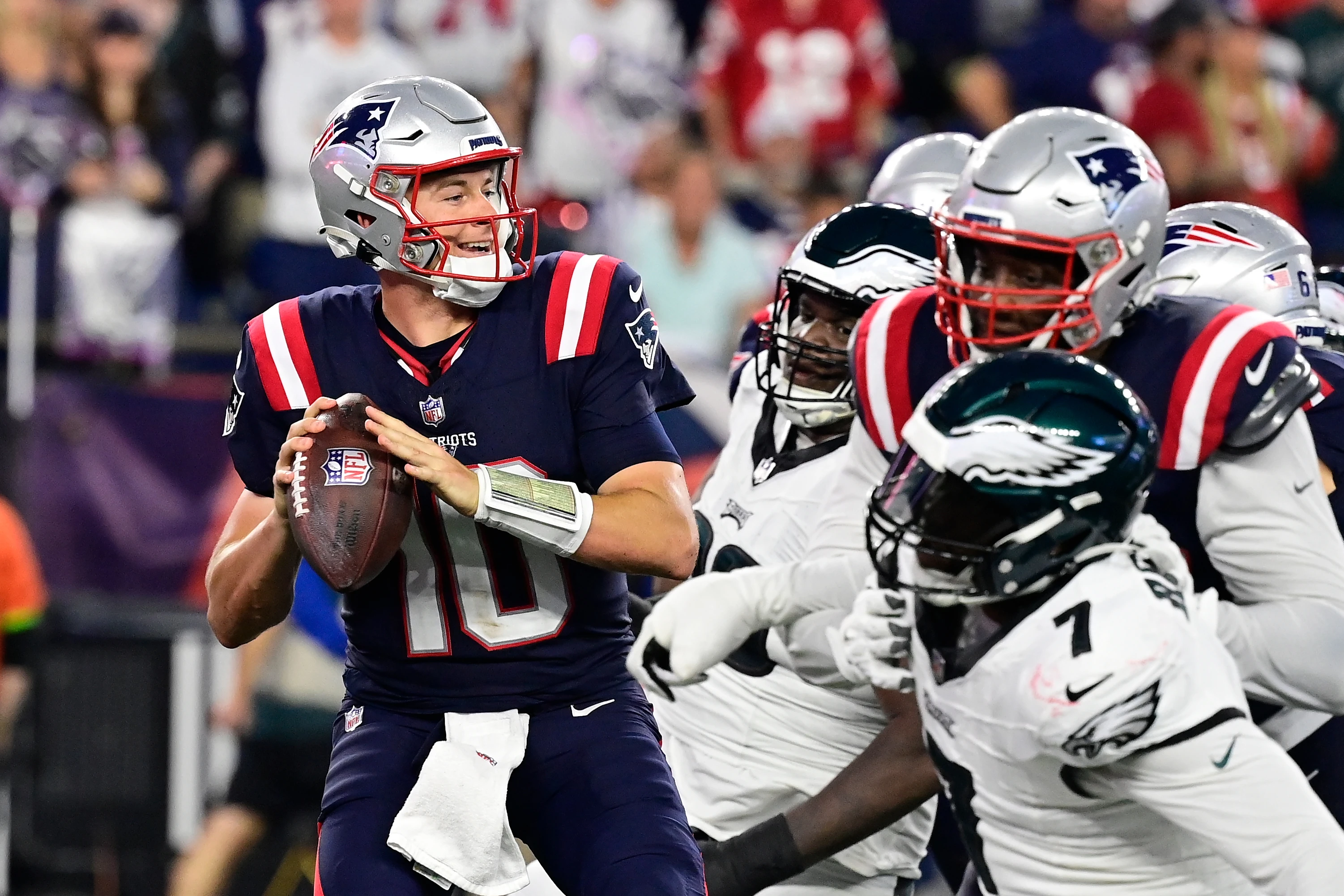 Sep 10, 2023; Foxborough, Massachusetts, USA; New England Patriots quarterback Mac Jones (10) tries to throw a pass as the Philadelphia Eagles close in during the second half at Gillette Stadium.