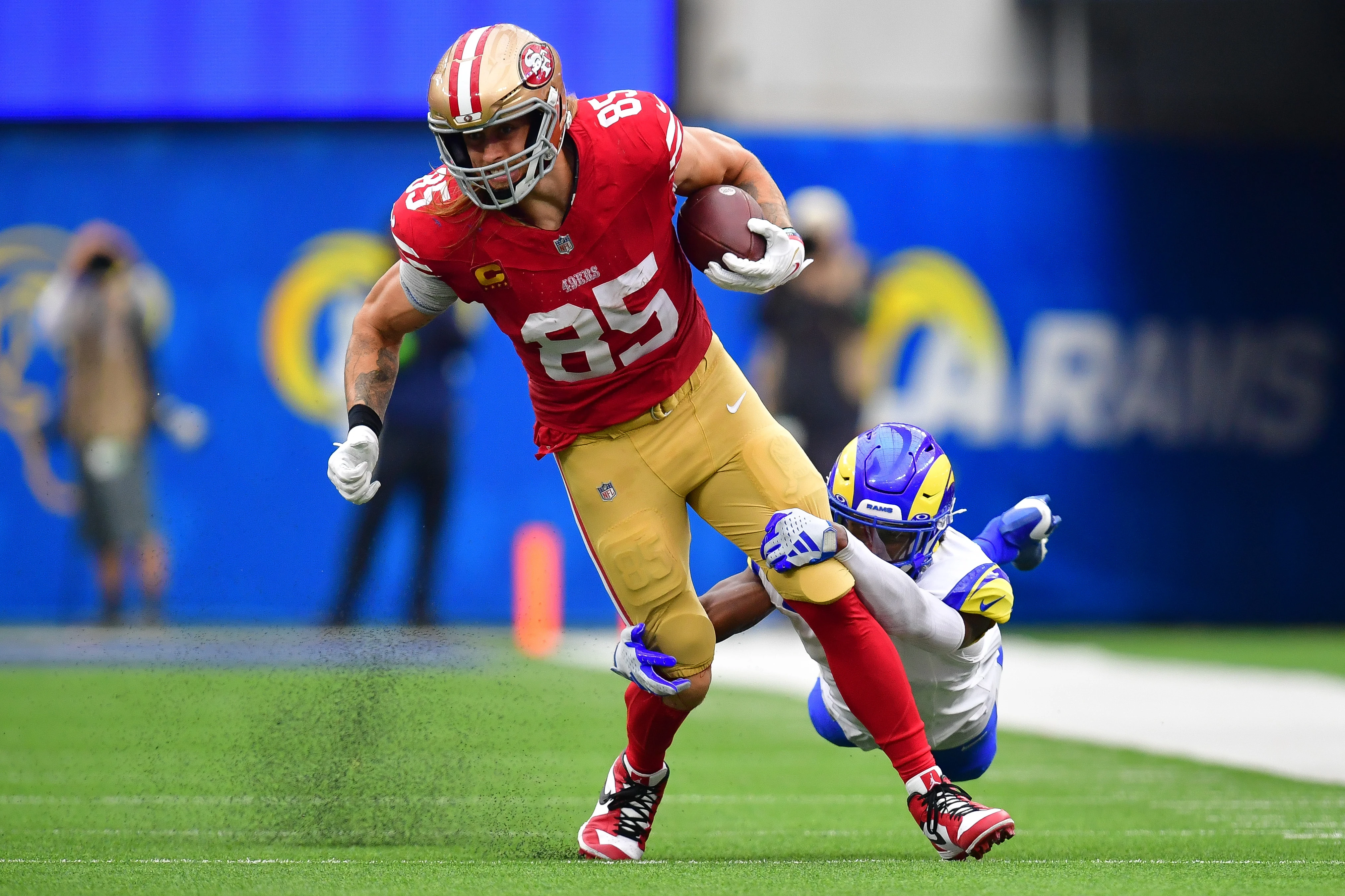 Sep 17, 2023; Inglewood, California, USA; San Francisco 49ers tight end George Kittle (85) runs the ball against Los Angeles Rams safety Jordan Fuller (4) during the second half at SoFi Stadium.
